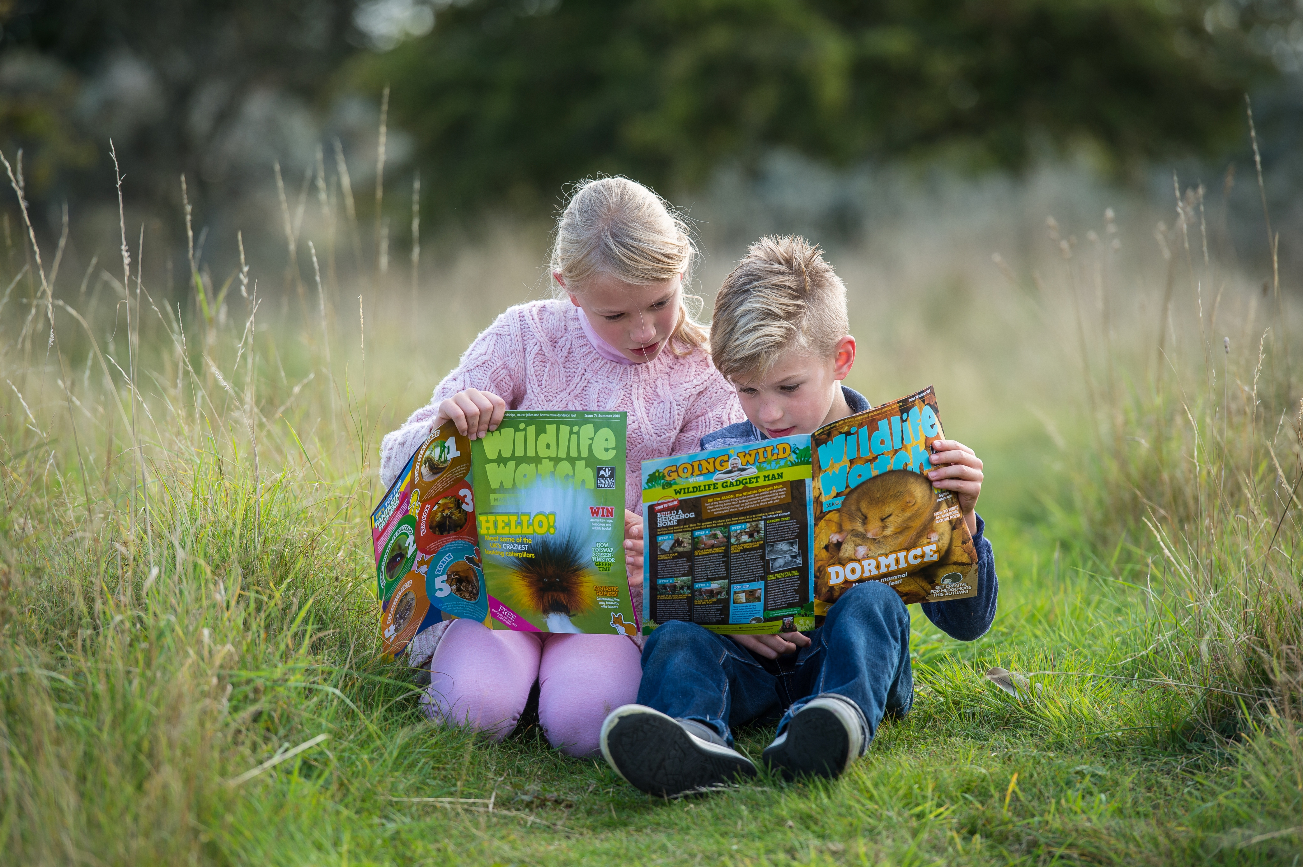 children reading their wildlife watch magazines” style=