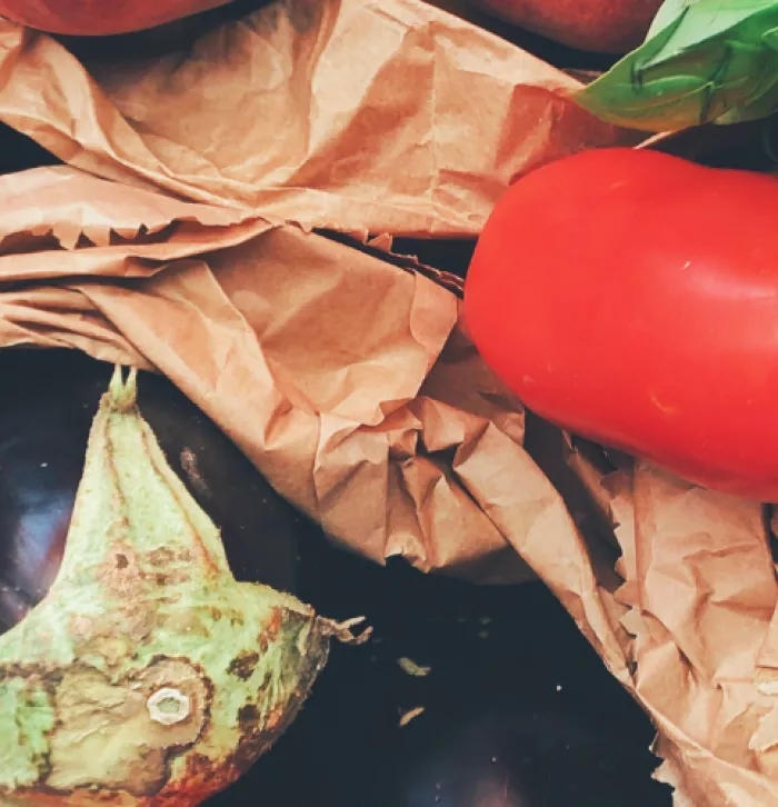 Healthy food like aubergines and basil and tomatoes all wrapped up in biodegradable packaging