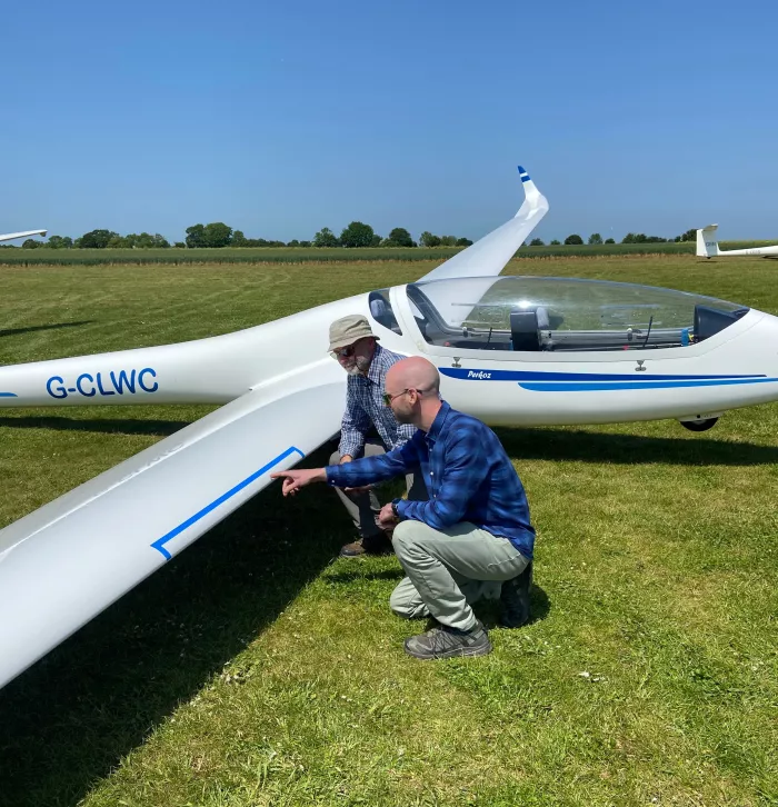 Lawrence KWT and Adrian Gliding club counting insect splats on glider wing for bugs matter