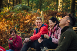 Children and families outdoors in woodland, photo by Helena Dolby for Sheffield & Rotherham Wildlife Trust