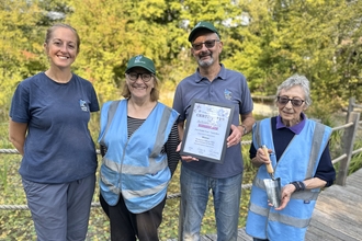 Group of volunteers with award certificate