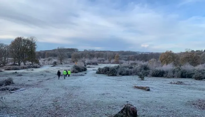 Volunteers at Hothfield Heathland in winter with frost on the grass.