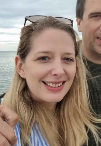 A profile photo of Hollie Du Preez, Head of Strategic Conservation Initiatives, in front of the sea.