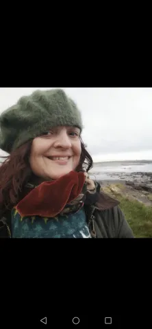 Rachel Rodwell, smiling by the sea shore.