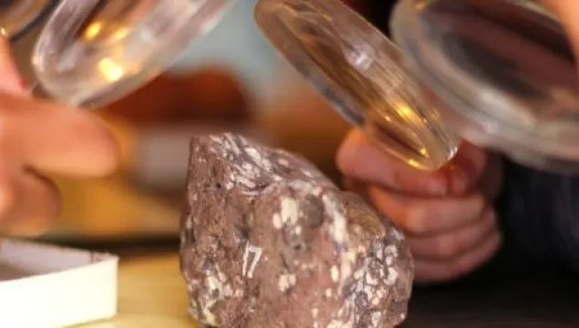 looking at rocks through a magnifying glass