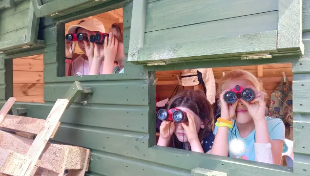 Kids looking for birds with binoculars at Holiday Club