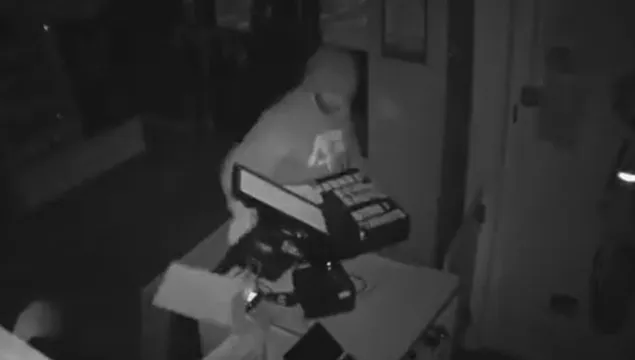 CCTV still showing man snatching the till