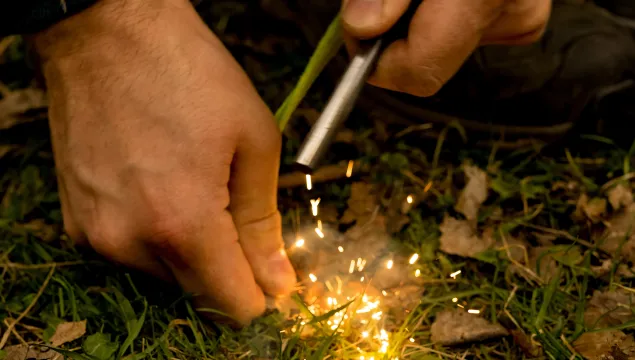 Making sparks to start a campfire.