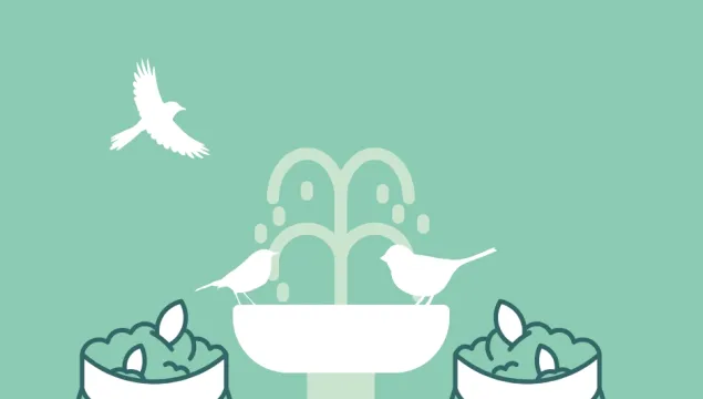 two compost bags with a bird bath in the background