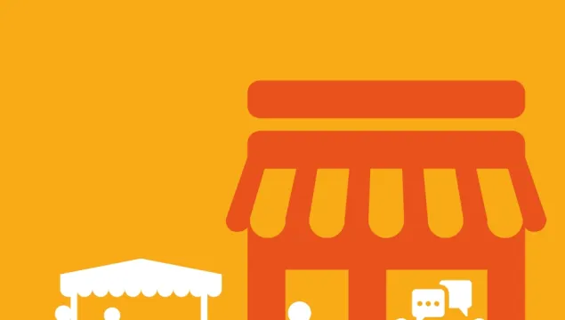 people chatting at a table, a person shopping and a small stall holder