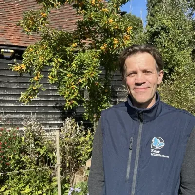 Ben Dart, Chief Operating Officer at KWT, smiling outside of Tyland Barn.