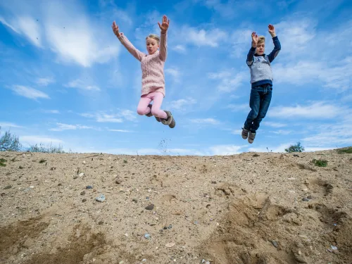 Children playing and jumping outdoors, photo by Matthew Roberts