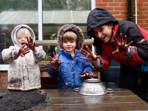 children playing with mud pies