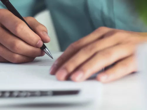 A person writing a letter 