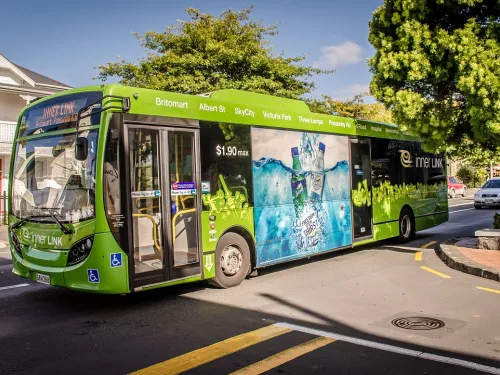 Green Bus driving on street