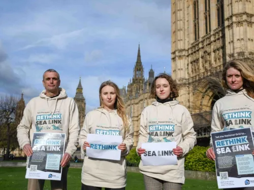 Four Kent Wildlife Trust employees outside the Houses of Parliament in Rethink Sea Link hoodies.