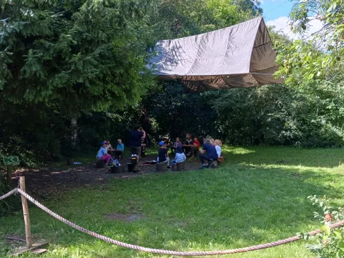 A forest school group underneath a shelter