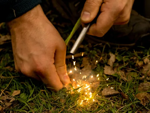 Making sparks to start a campfire.