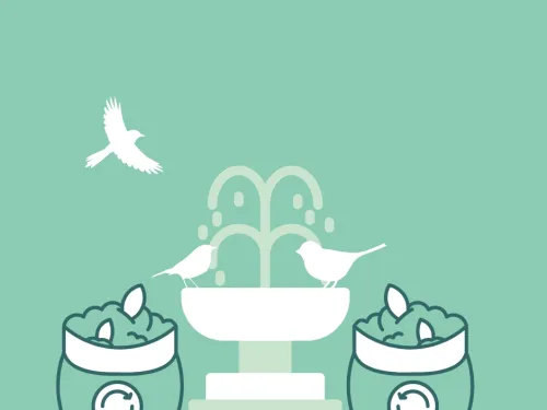 two compost bags with a bird bath in the background