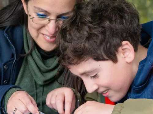 A child and adult dissecting owl pellets