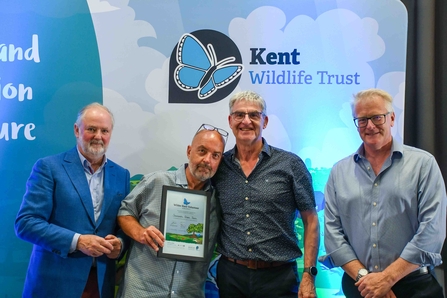 Sevenoaks Green Team standing with a Wilder Kent Volunteer Award certificate.