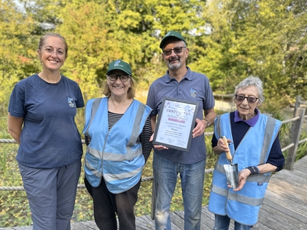 Group of volunteers with award certificate