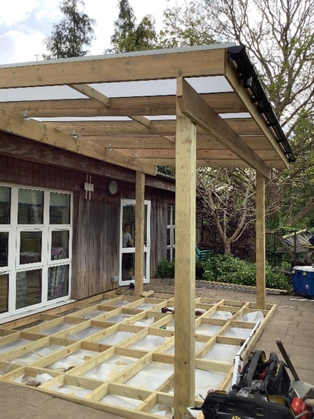 A wooden pergola under construction