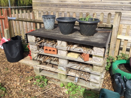 A bug hotel made out of wooden pallets