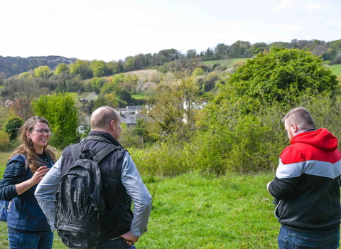 Three people standing outside as part of the Wilder Wellbeing programme